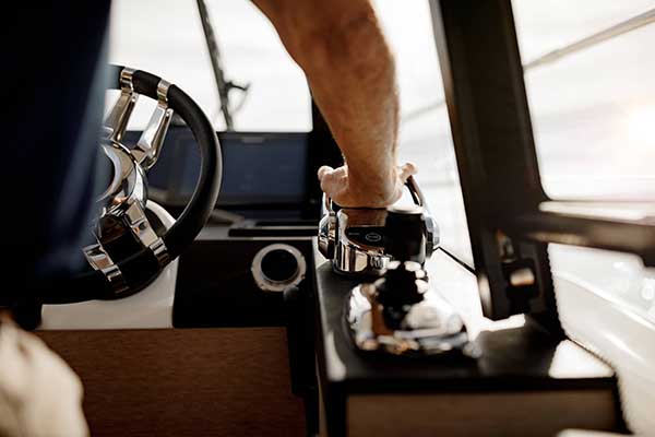 close up of man operating the 420S steering wheel in the cockpit