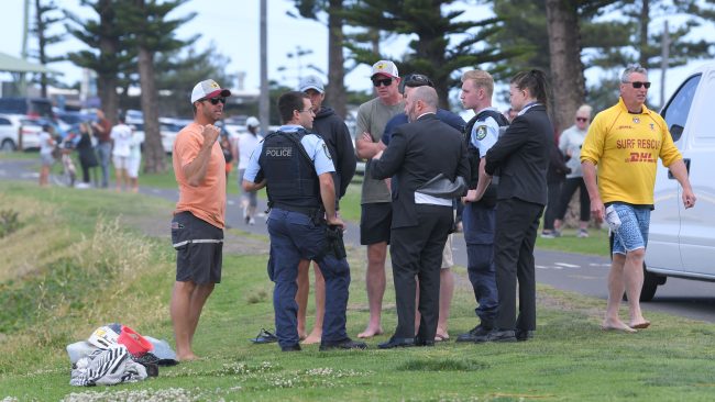People with police after boat capsizes in Waniora Point, Bulli