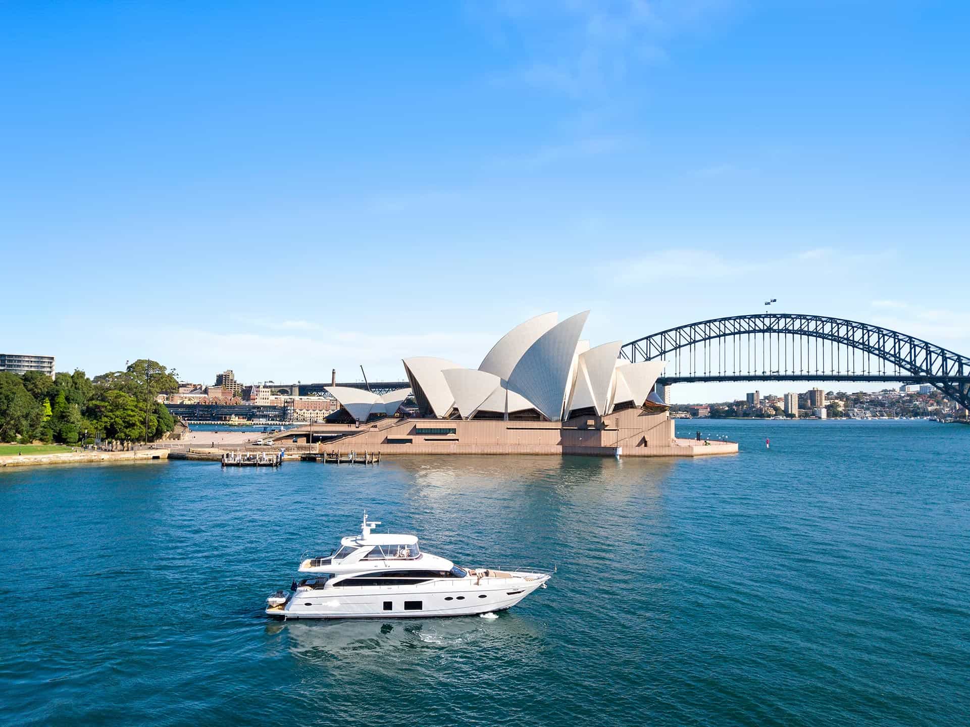Motor yacht infront of the Sydney Opera House and harbour bridge