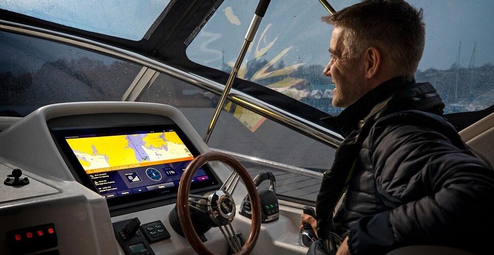 Man at the helm of Volvo Penta assisted docking equipped vessel