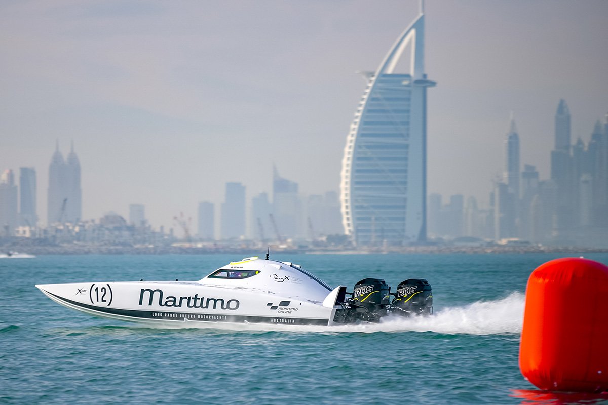 Maritimo racing powerboat cruising side profile with Dubai in background