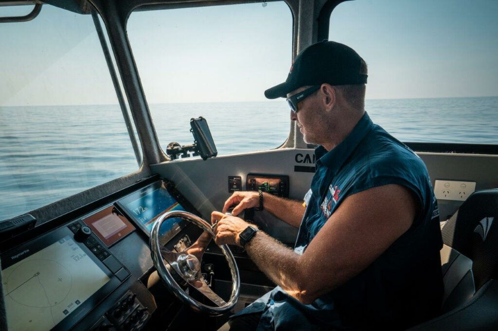Jase Andrews infront of a Raymarine powered helm