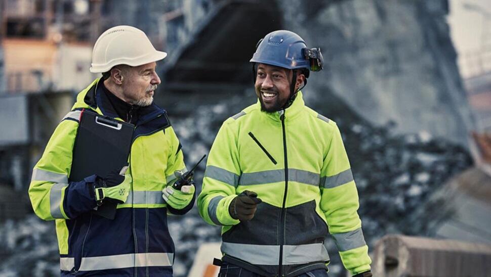 Two workers in hi-vis on volvo penta site