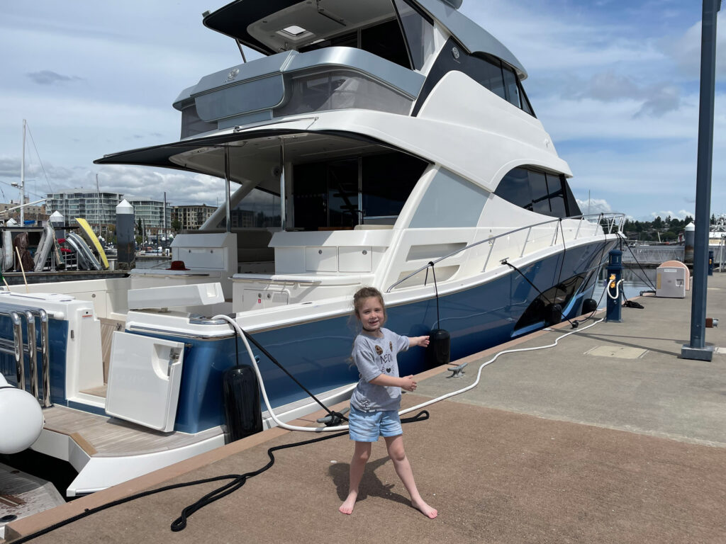 owner's daughter standing on dock infront of Riviera 64 Sports Yacht