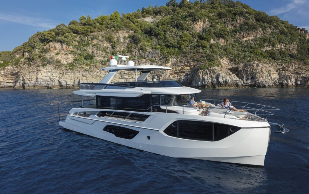 Absolute Navetta 64 with land in background anchored