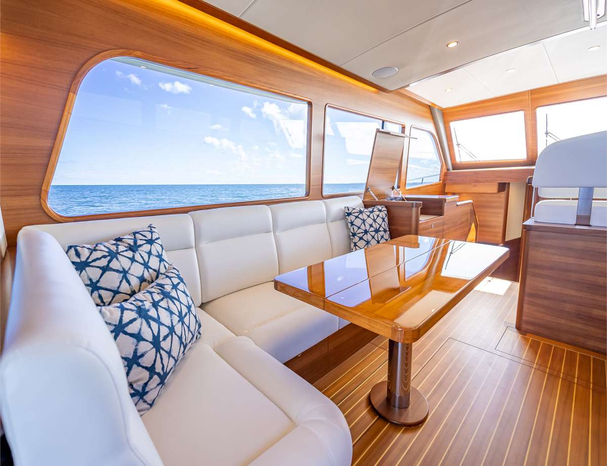 The Grand Banks 54 saloon features understated luxury with sumptuous white upholstery and teak flooring